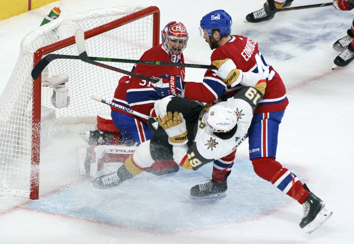 Vegas Golden Knights' Reilly Smith (19) is taken out by Montreal Canadiens defenseman Joel Edmu ...