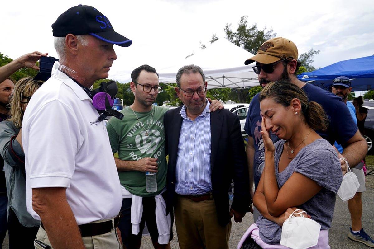 The Mayor of Surfside Charles Burkett, left, talks with Rachel Spiegel, right, who is looking f ...