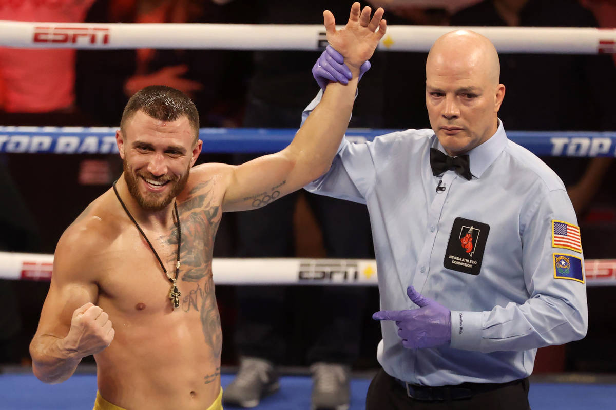 Vasyl Lomachenko poses after winning by way of technical knockout in a lightweight bout against ...