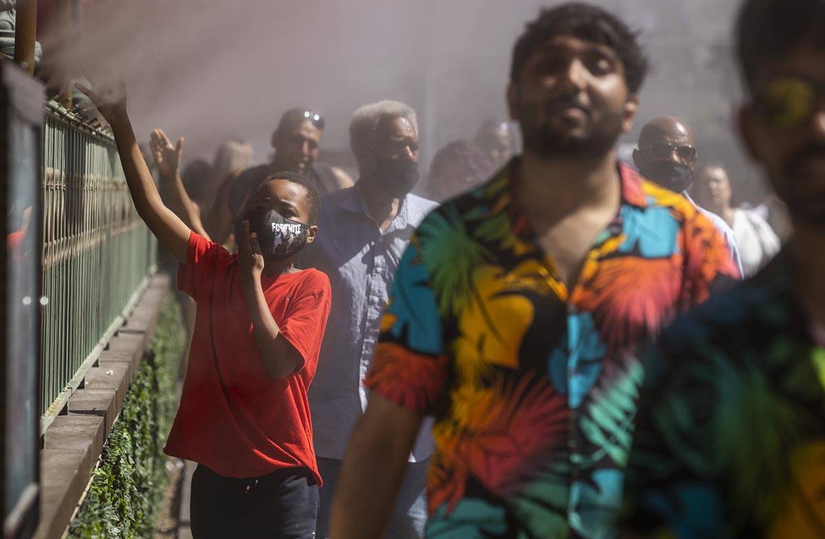 Keith Batiste, 10, of California and others cool off in misters outside the Paris Las Vegas as ...