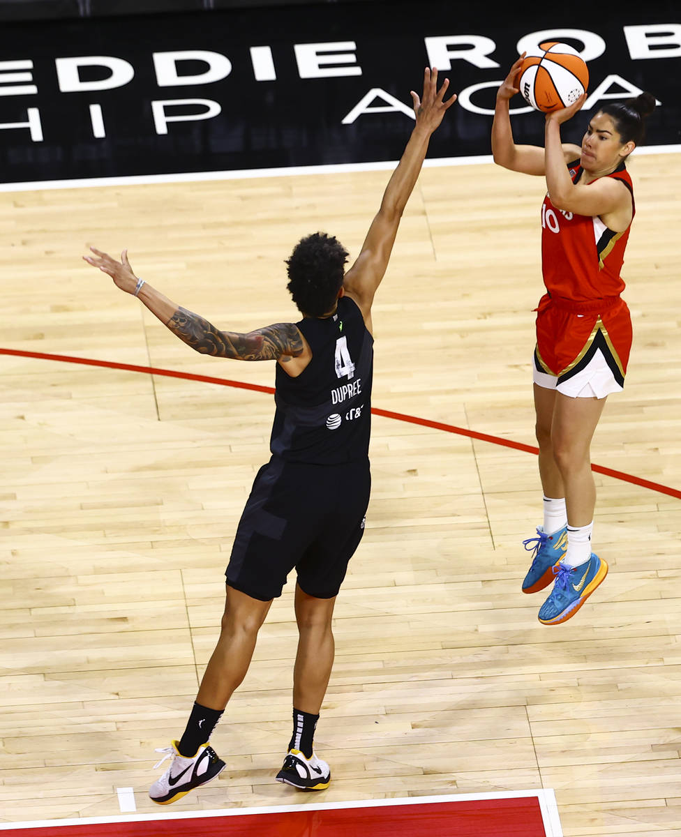 Las Vegas Aces' Kelsey Plum (10) shoots over Seattle Storm's Candice Dupree (4) during the firs ...
