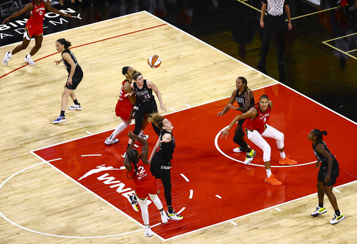 Las Vegas Aces' Chelsea Gray (12) shoots to score over Seattle Stormճ Breanna Stewart in the f ...