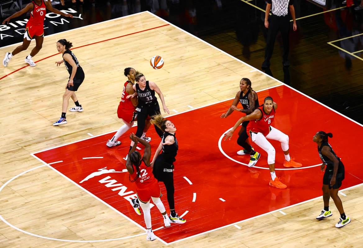 Las Vegas Aces' Chelsea Gray (12) shoots to score over Seattle Stormճ Breanna Stewart in the f ...
