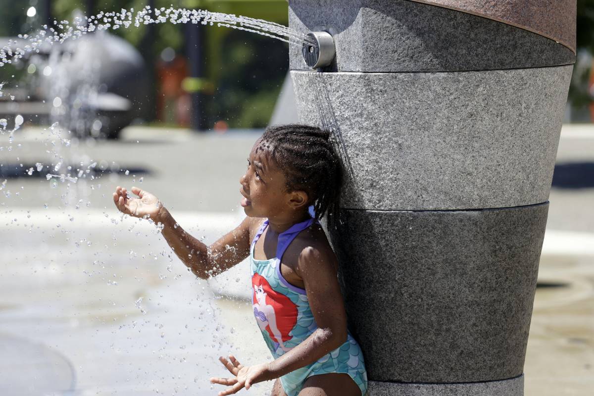 Mellena O'Brien, 4, plays in the Yesler TerraceSpray Park during a heat wave hitting the Pacifi ...