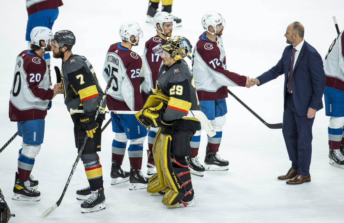 Golden Knights goaltender Marc-Andre Fleury (29) and head coach Peter Deboer, right, with teamm ...