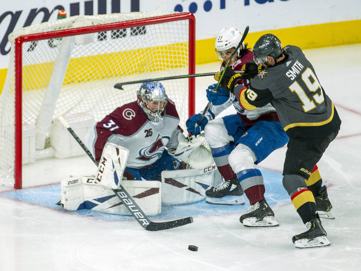 Colorado Avalanche goaltender Philipp Grubauer (31) and teammate defenseman Ryan Graves (27) de ...