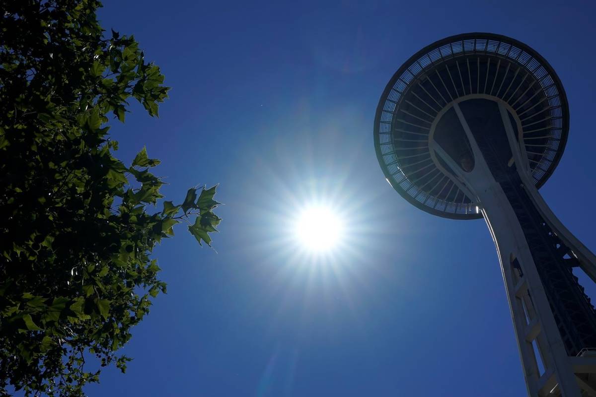 The sun shines near the Space Needle, Monday, June 28, 2021, in Seattle. (AP Photo/Ted S. Warren)