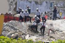 Workers cut a large slab of concrete at the Champlain Towers South condo, Monday, June 28, 2021 ...