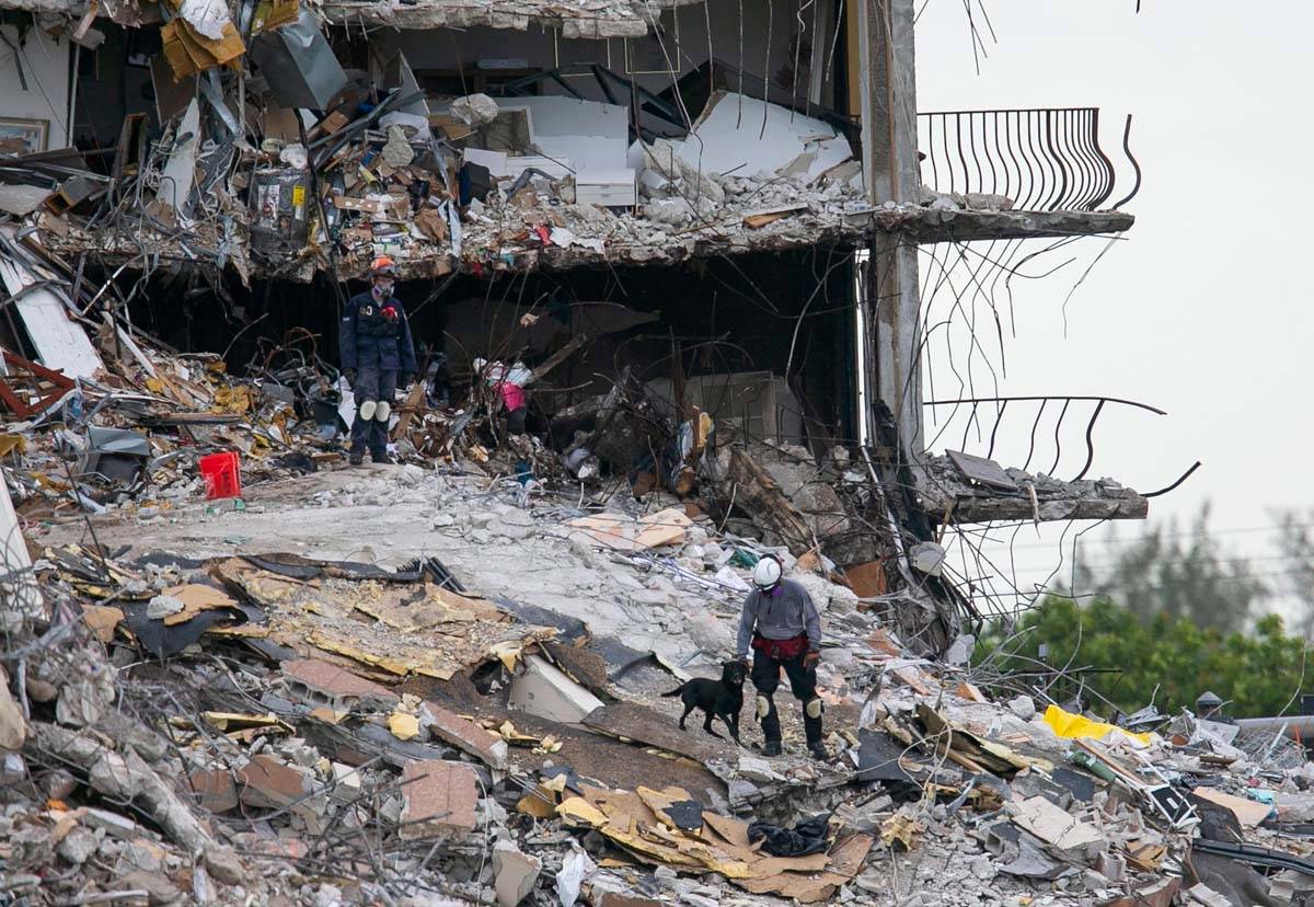 South Florida Urban Search and Rescue team look through rubble for survivors at the partially c ...