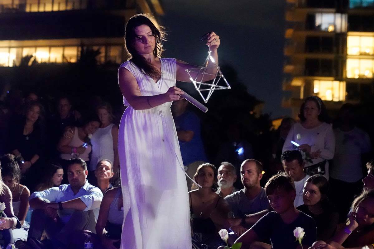 Michelle Cash plays a quartz crystal merkaba during a vigil ...