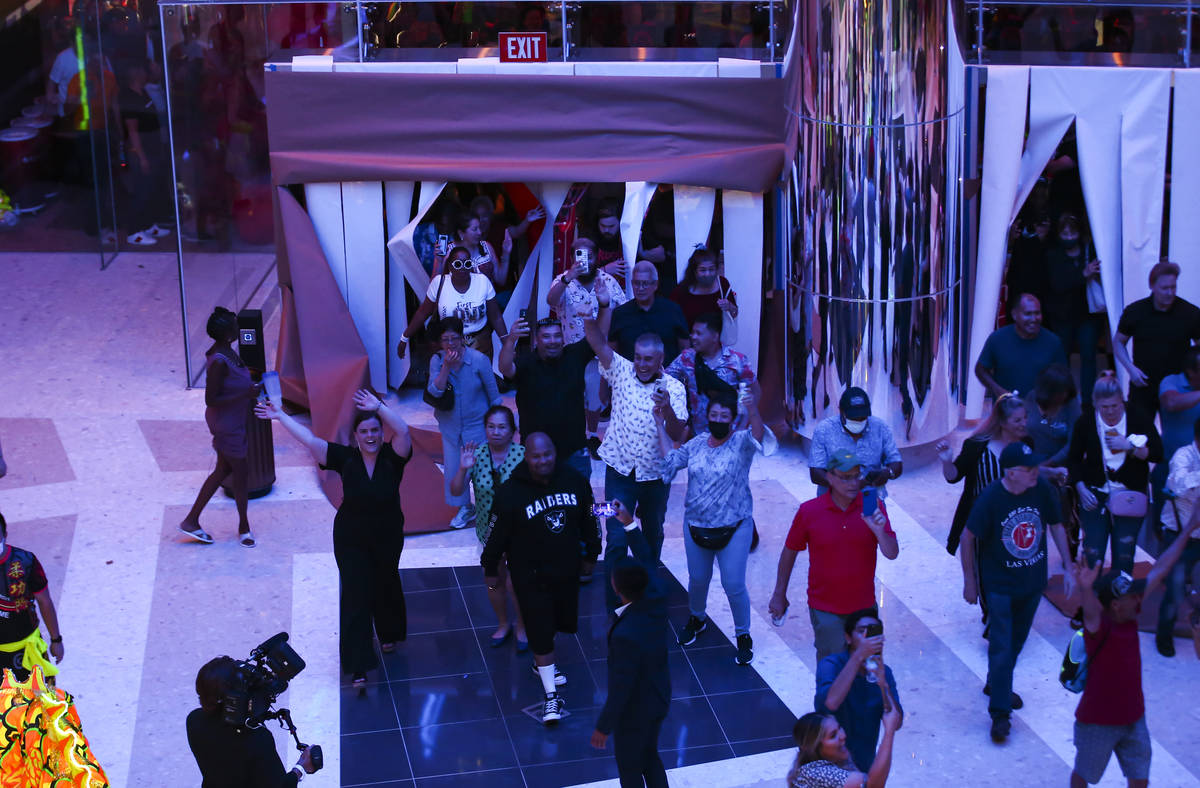 People walk into The District as the doors open to the public at Resorts World Las Vegas on Thu ...