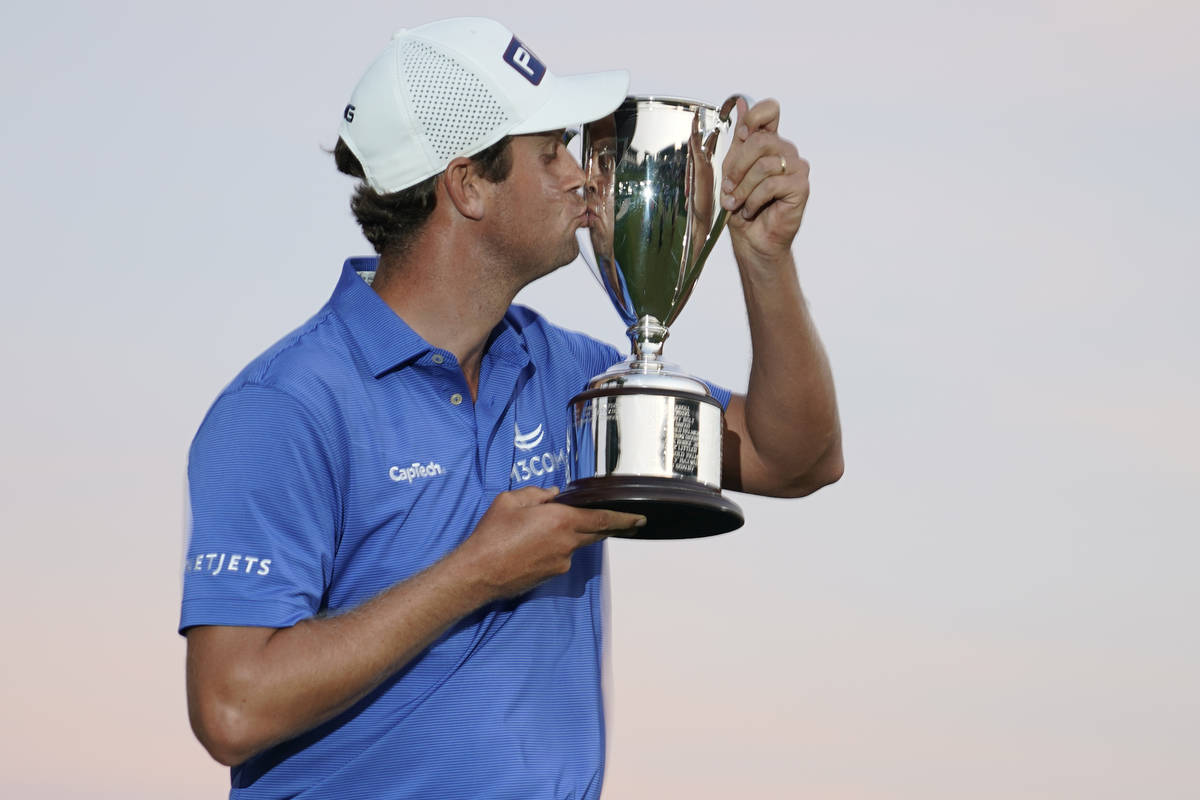 Harris English kisses the winners trophy after winning the Travelers Championship golf tourname ...