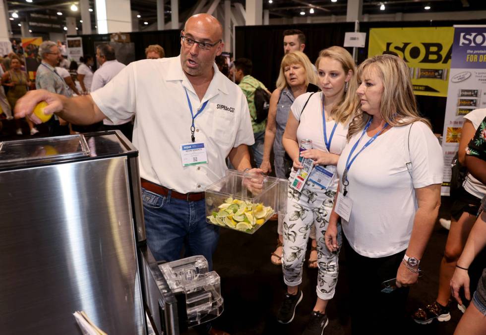 Kevin Szakacs from Las Vegas demonstrates his automatic slicer to Janine Andrews, right, and Kait ...