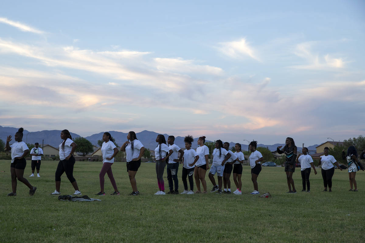 Members of Superior Squad drill and drum squad perform at a vigil for their late teammate, 18-y ...