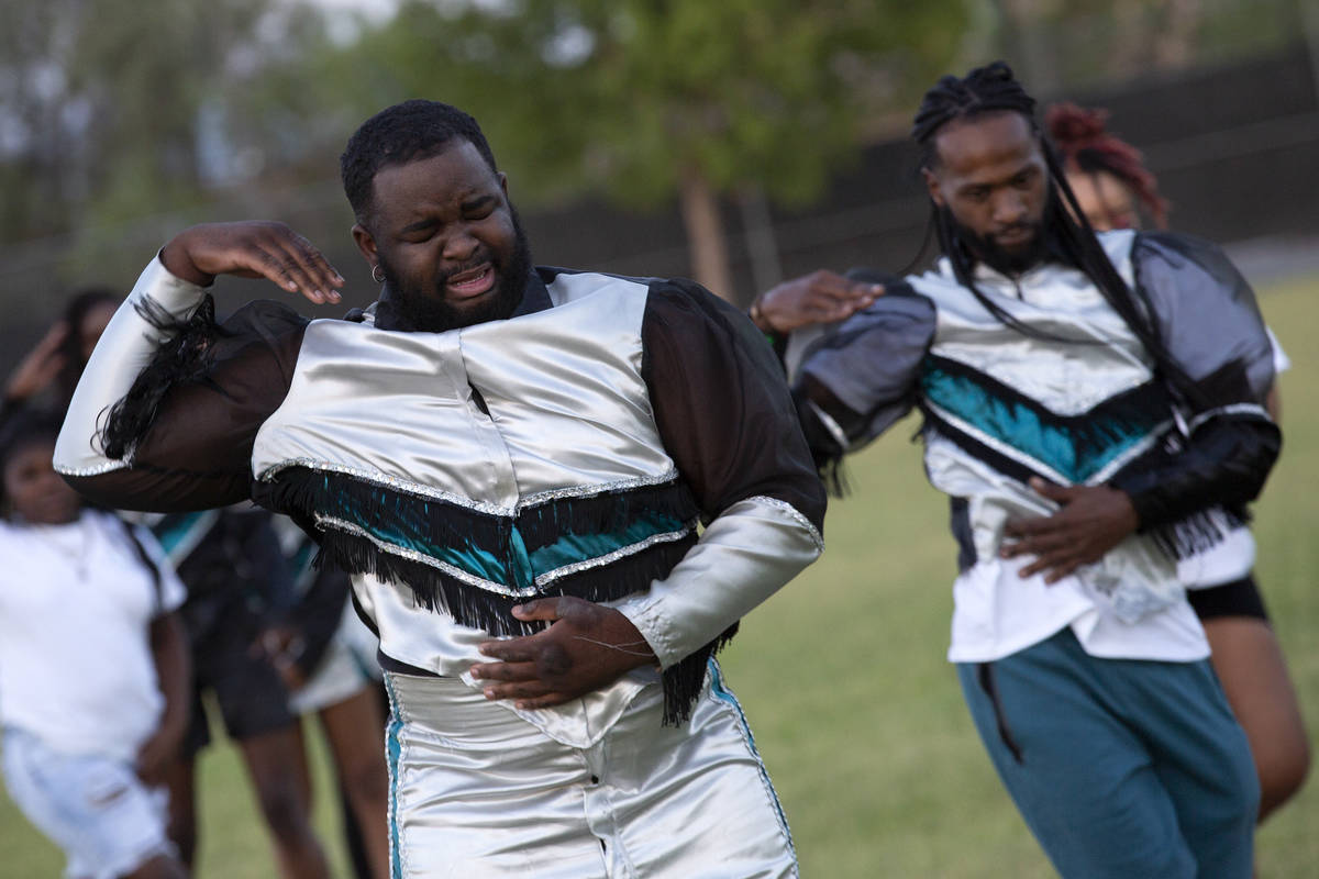 Jensy Rodriguez, co-director of Superior Squad drill and drum squad, left, tears up while perfo ...