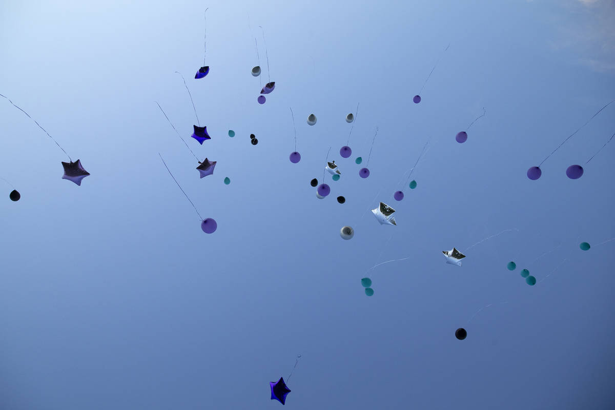 Balloons are released into the sky in honor of 18-year-old Shania James, who was shot and kille ...