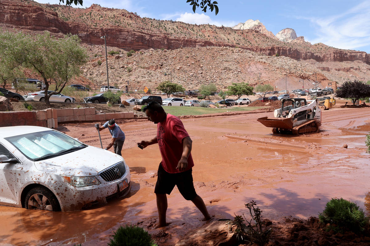 Julio Lopez, right, gets help freeing his car in Zion Canyon Village in Zion National Park near ...