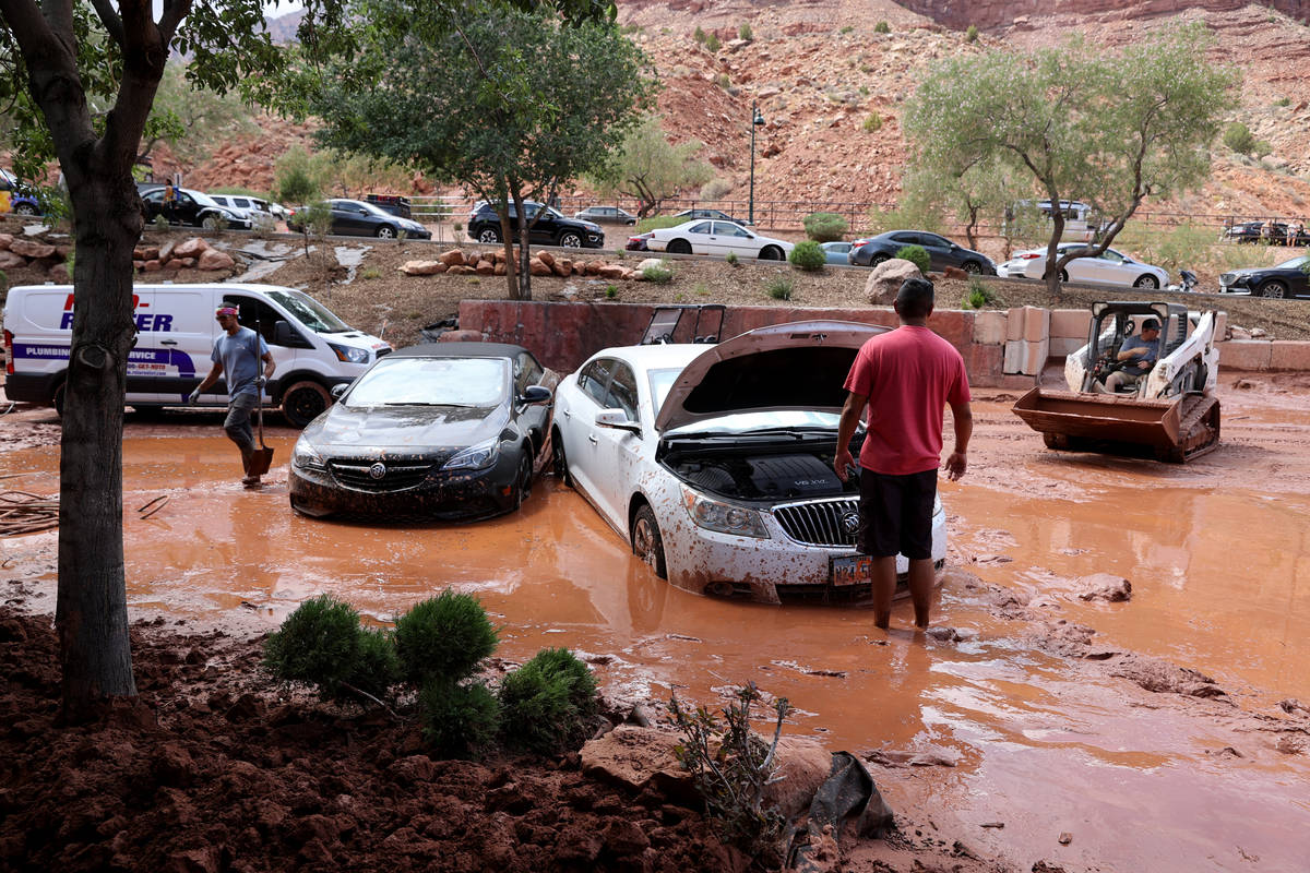 Julio Lopez, right, gets help freeing his car in Zion Canyon Village in Zion National Park near ...