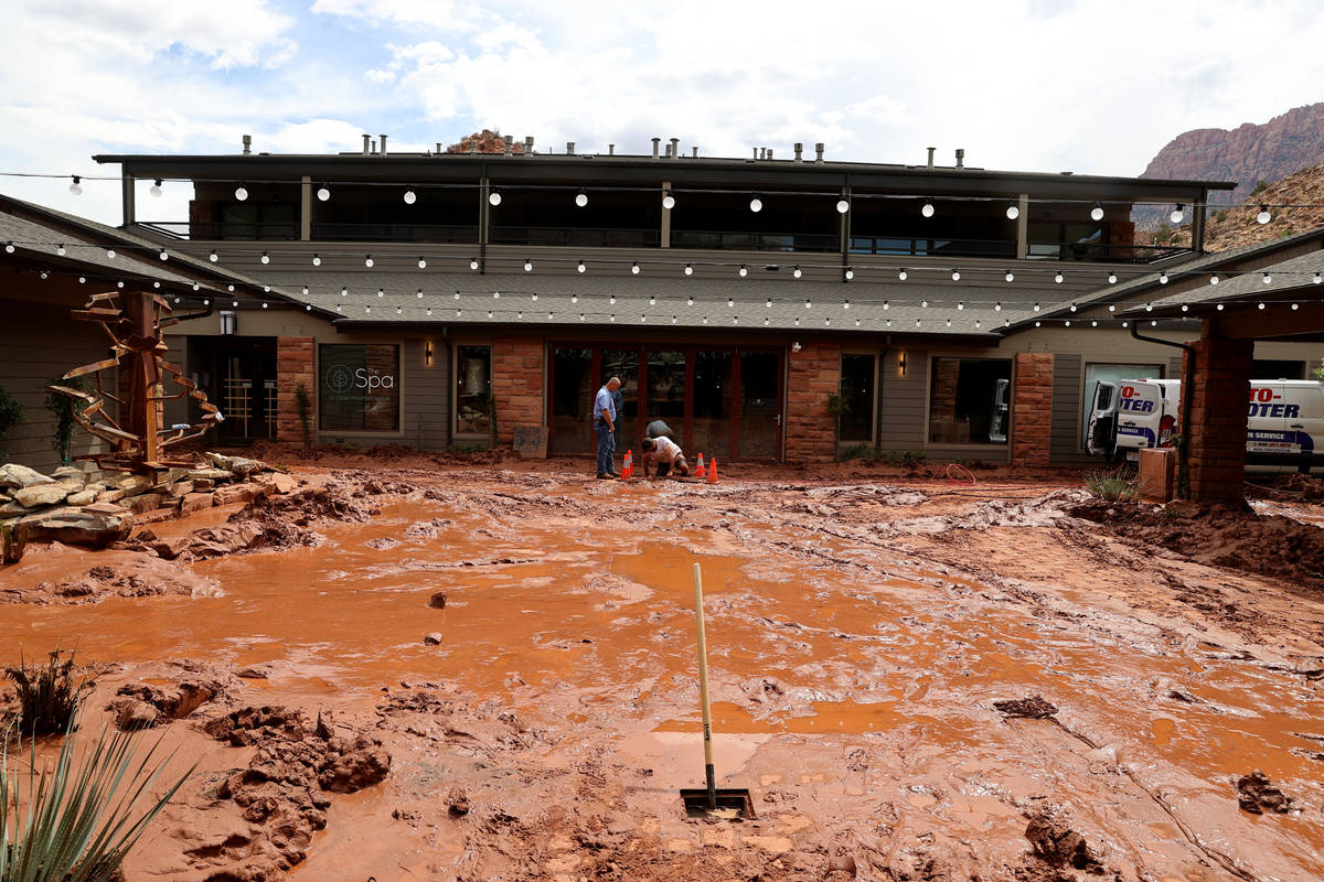 Workers clear a drain at Cable Mountain Lodge in Zion Canyon Village in Zion National Park near ...