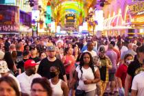 Visitors take in the sites at the Fremont Street Experience during Memorial Day weekend on Satu ...