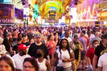 Visitors take in the sites at the Fremont Street Experience during Memorial Day weekend on Satu ...