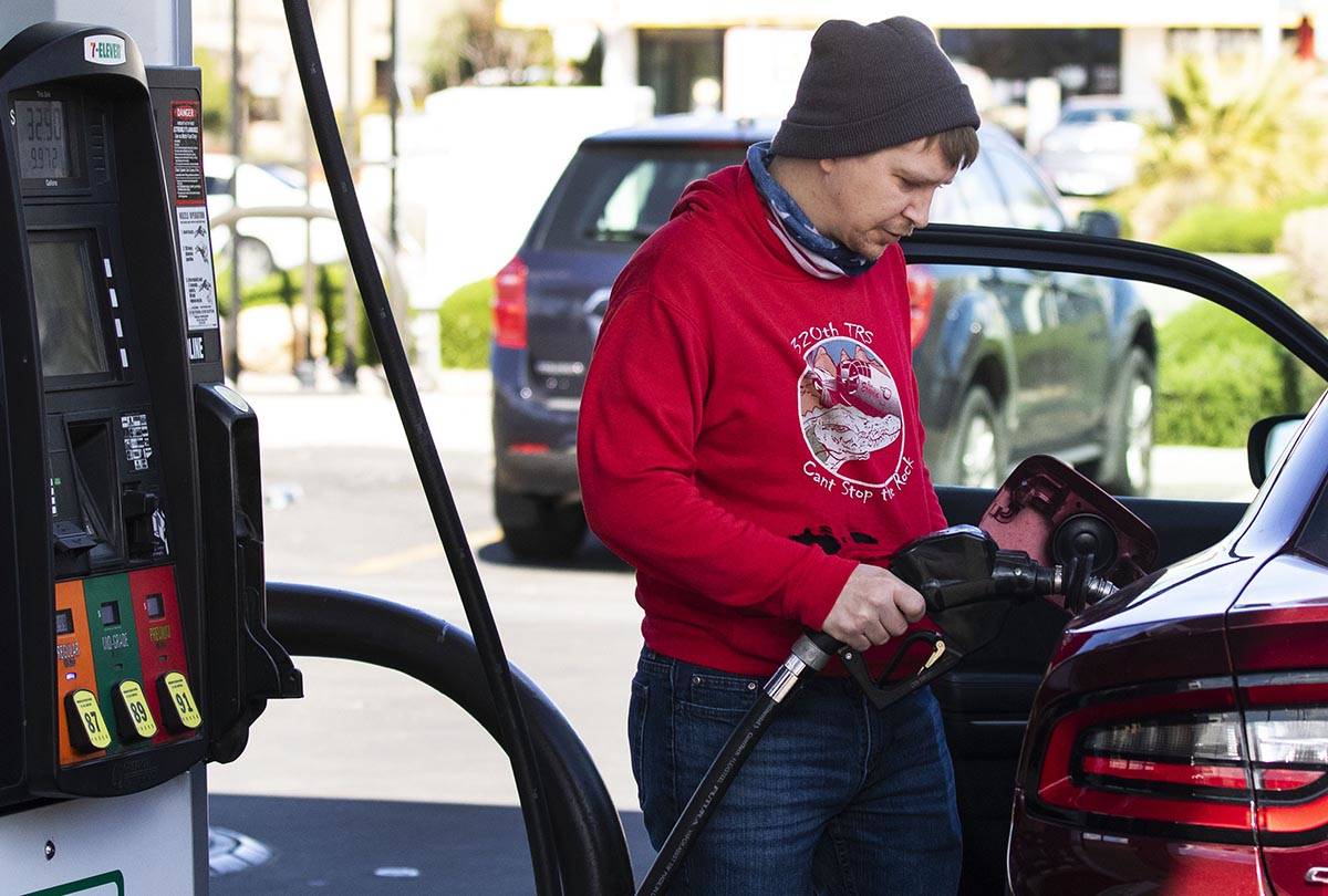 Brandon Edester pumps gas at a 7-Eleven on Monday, March, 15, 2021, in Las Vegas. (Bizuayehu Te ...