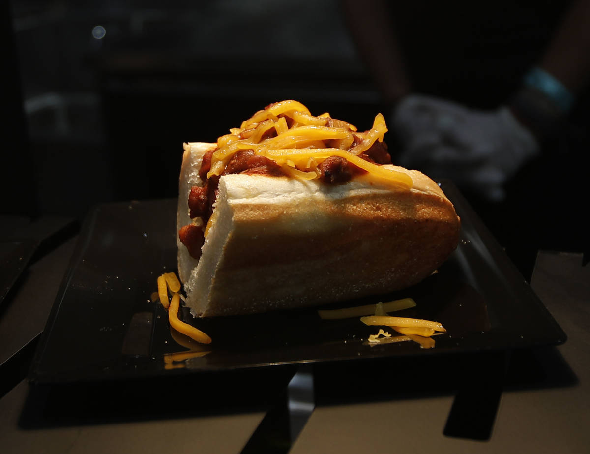 A Rollin Smoke Barbecue's brisket chili cheese dogs are served during an event of food and beve ...