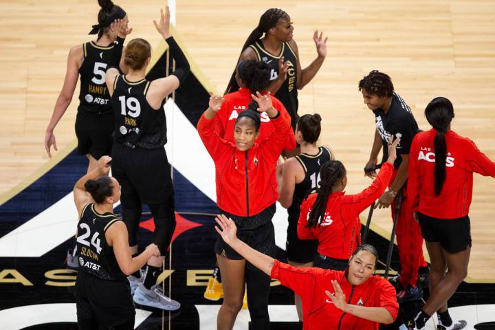 The Las Vegas Aces, including forward A'ja Wilson, center, and center Liz Cambage, bottom right ...