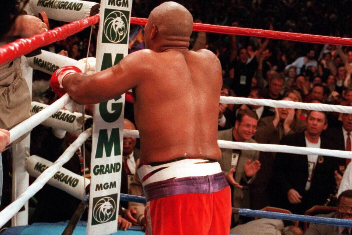 George Foreman kneels and prays after knocking out Michael Moorer in the 10th round on Nov. 5, ...