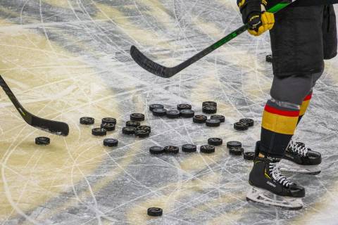 Pucks pile up on the ice as the Vegas Golden Knights warm up before the first period of their N ...