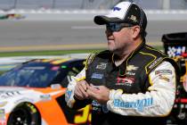 Brendan Gaughan walks along pit road during NASCAR auto race qualifying at Daytona Internationa ...
