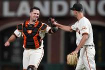 San Francisco Giants catcher Buster Posey, left, celebrates with pitcher Tyler Rogers after the ...