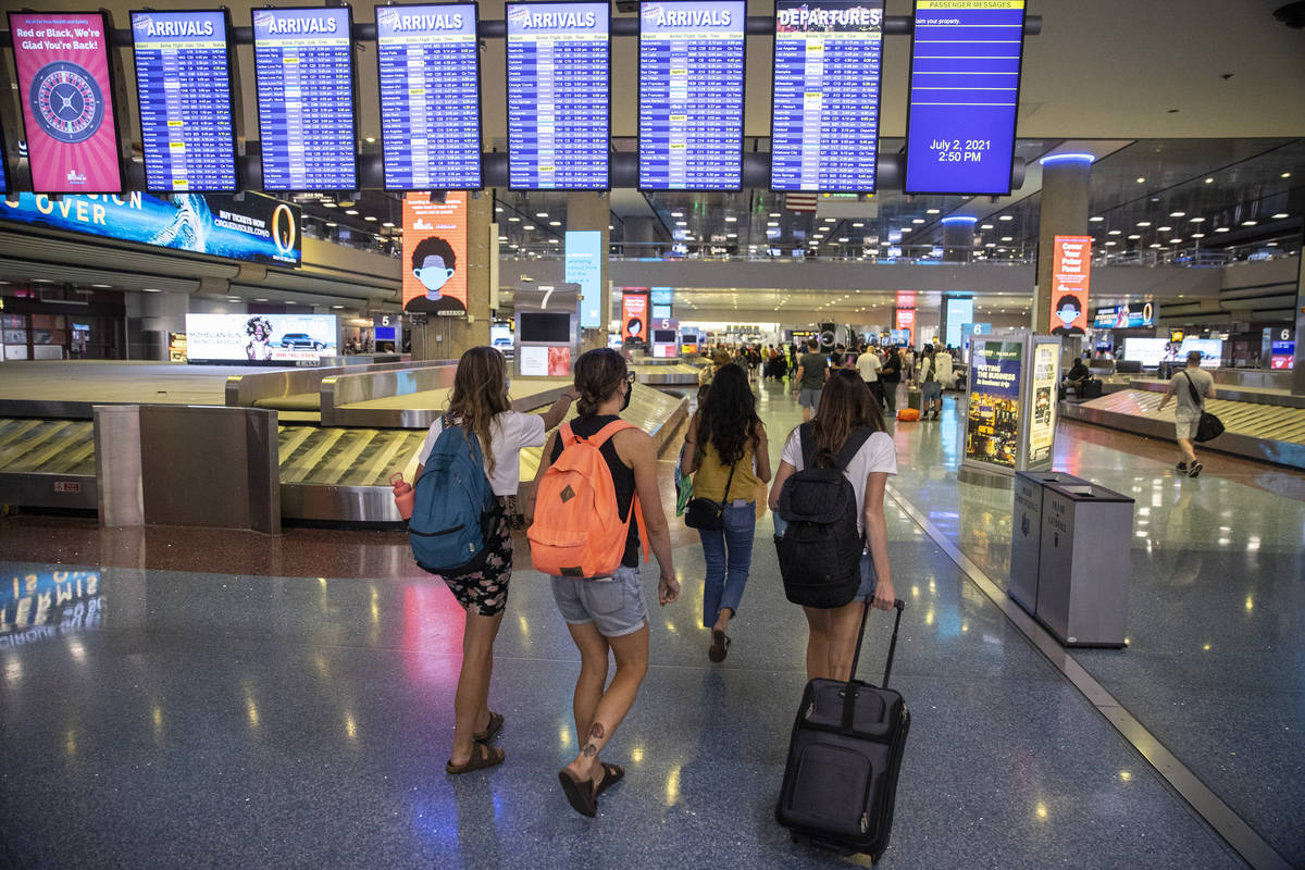 People arrive at McCarran International Airport Terminal 1 in Las Vegas, Friday, July 2, 2021. ...