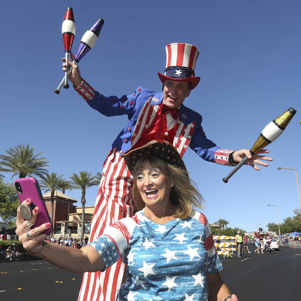 Kathy Koch takes a photo with a man dressed as Uncle Sam during the 25th annual Summerlin Counc ...