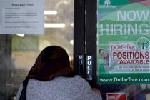 A shopper enters a retail store as a hiring sign shows in Buffalo Grove, Ill., Thursday, June 2 ...