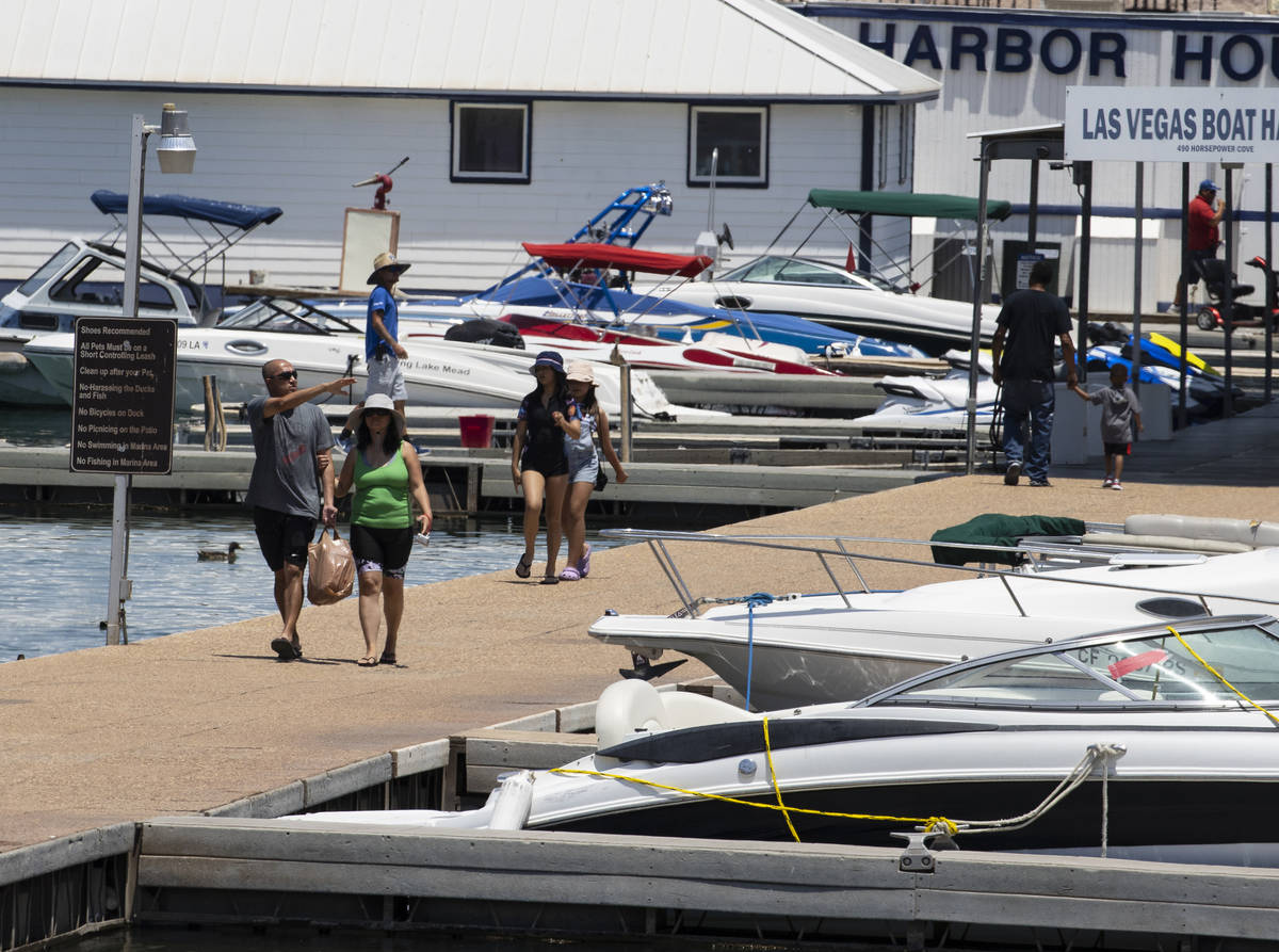 People walk on the pier at the Las Vegas Boat Harbor in the Lake Mead National Recreation Area, ...