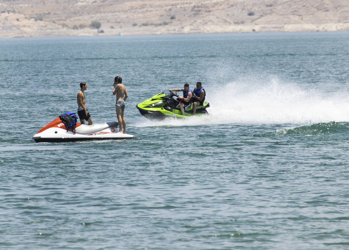 People relax at Boulder Beach in the Lake Mead National Recreation Area, on Friday, July 2, 202 ...