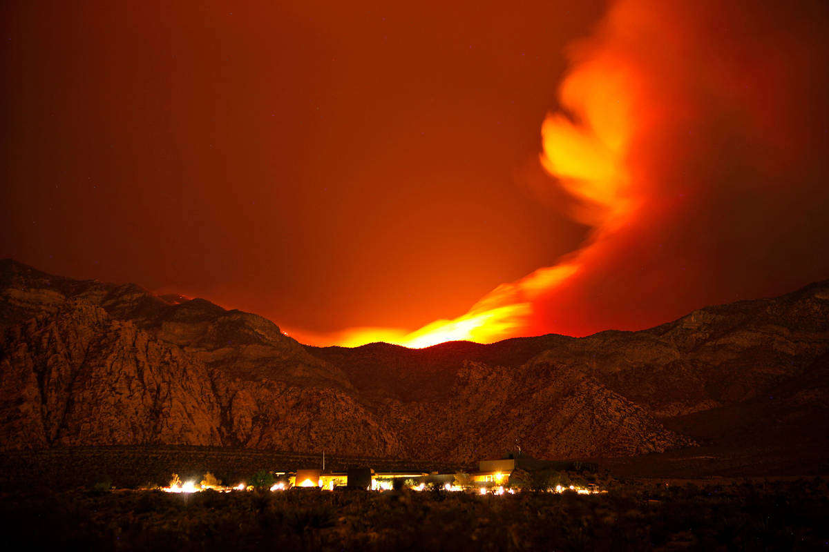 The Carpenter 1 Fire burns in the mountains behind the Red Rock Conservation Area visitor cente ...