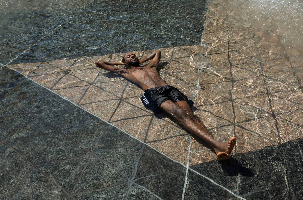 Kais Bothe relaxes in the cool in the city hall pool, as temperatures hit 37 degrees Celsius in ...
