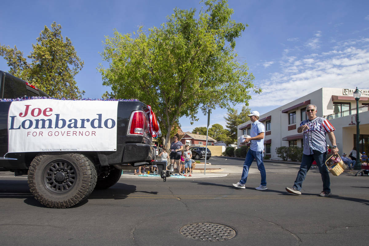 Clark County Sheriff Joe Lombardo, right, marches through the Damboree parade to promote his ru ...