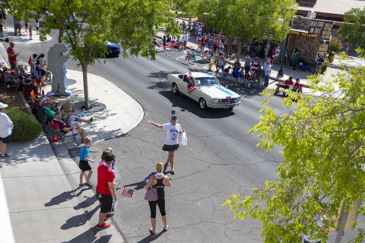 A woman hands out candy to parade watchers during the two-day Damboree event on Saturday, July ...