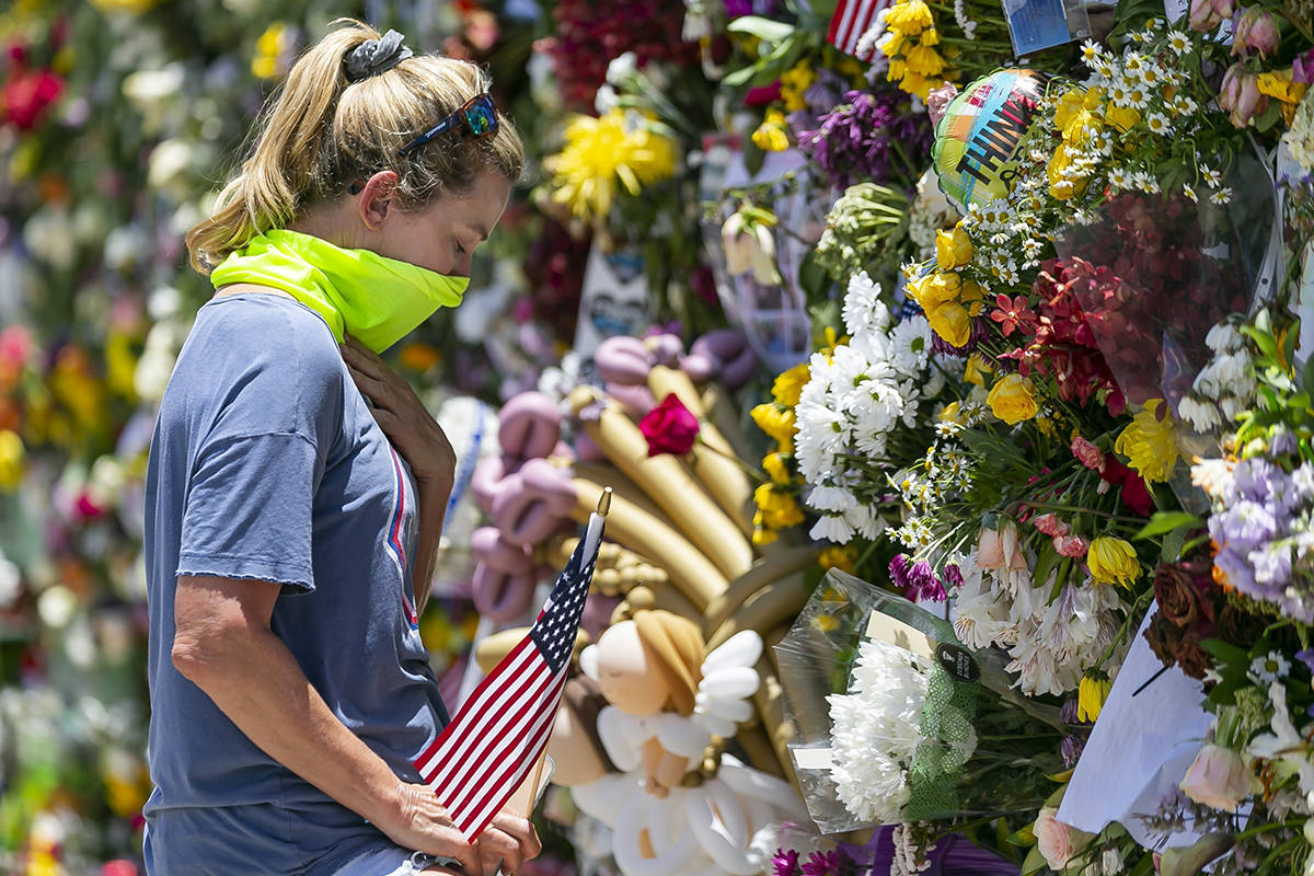 Miami Beach resident Tracey Lynne visits a makeshift memorial near the site of the collapsed Ch ...