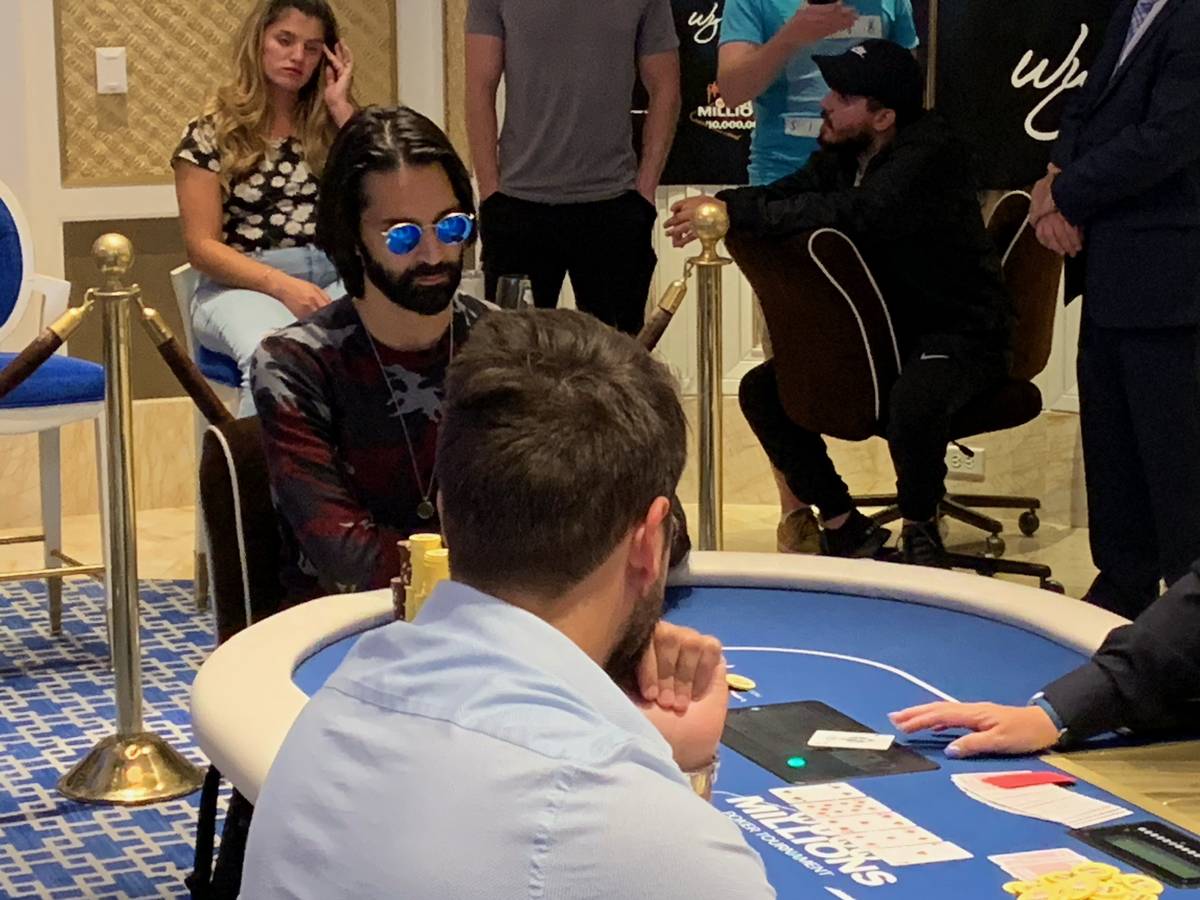 Andrew Moreno, wearning sunglasses, plays at the final table of the Wynn Millions on Saturday, ...