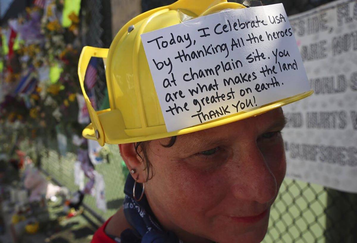 Hialeah resident Alison Kairuz is shown after pinning her hand-made sign to the fence in suppor ...