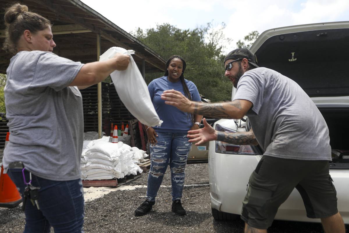New homeowner Breanna Landers, 30, of Brandon, thanks park rangers Elizabeth Peterson and Chad ...