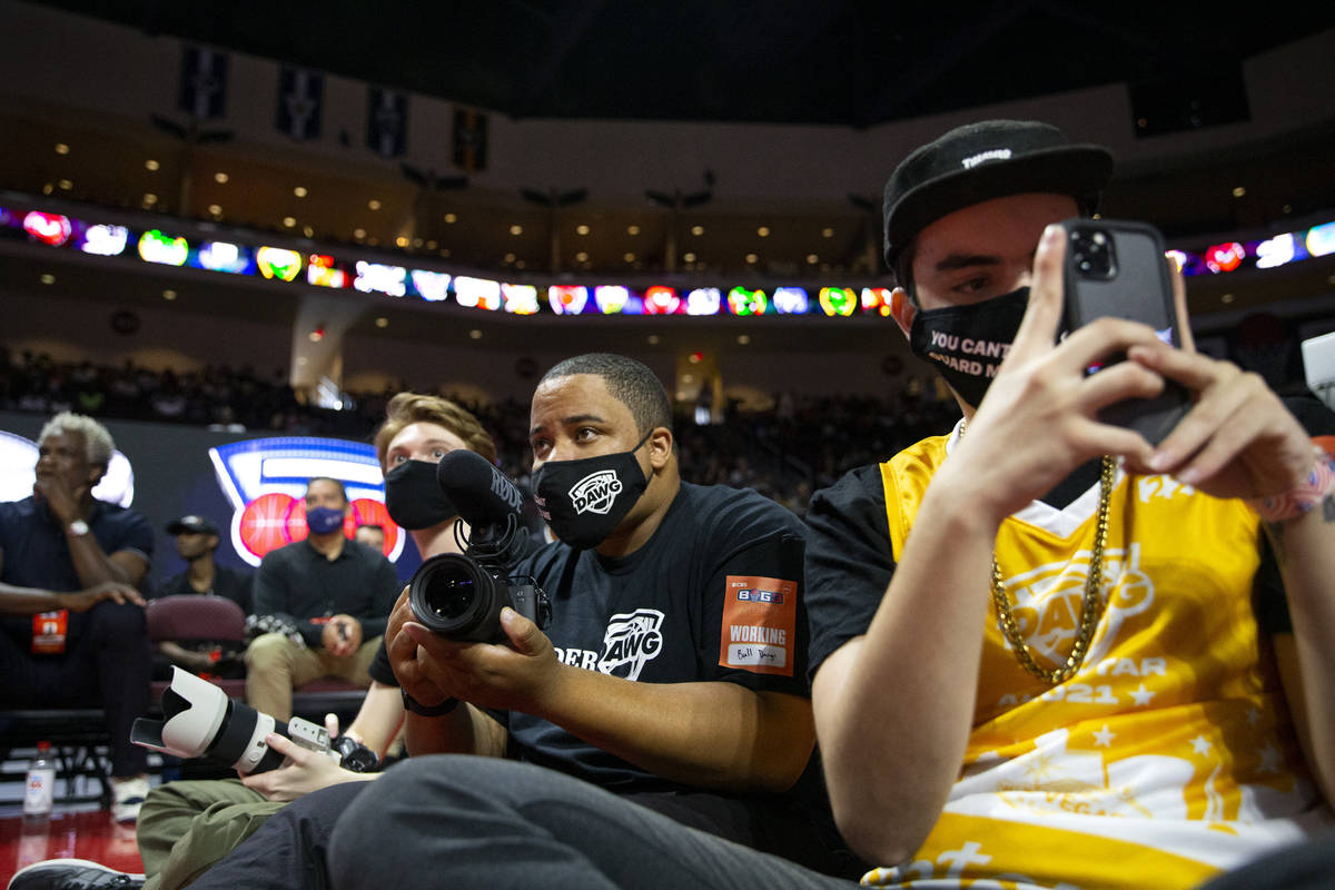 BallDawgs employees Jacob Machnik, left, Malik Ricks and Carter Garife record a BIG3 basketball ...