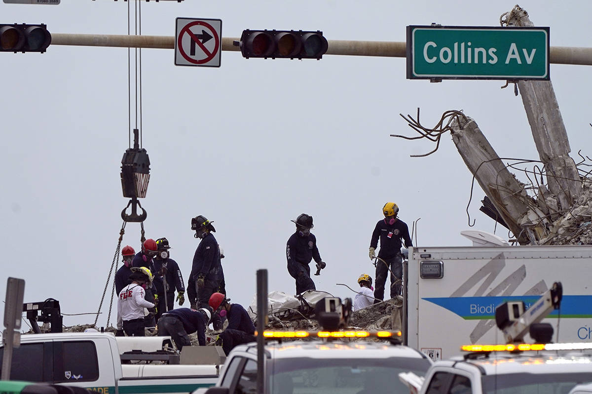 Rescue crews work in the rubble of the collapsed Champlain Towers South condominium building, T ...