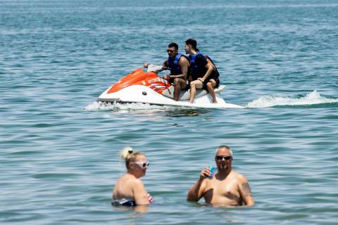 People relax at Boulder Beach in the Lake Mead National Recreation Area, on Friday, July 2, 202 ...