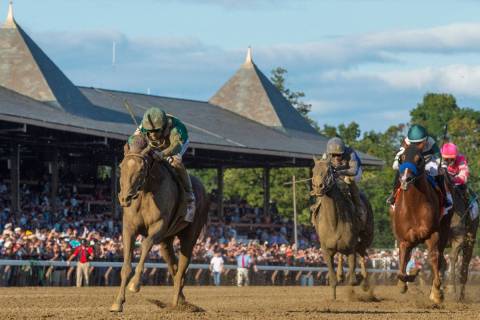 In this Aug. 24, 2019, file photo, Code of Honor, left, with jockey John Velazquez, leads the f ...