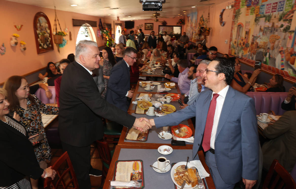 Gov. Steve Sisolak, left, greets Julian Escutia Rodriguez, consul of Mexico in Las Vegas, at th ...